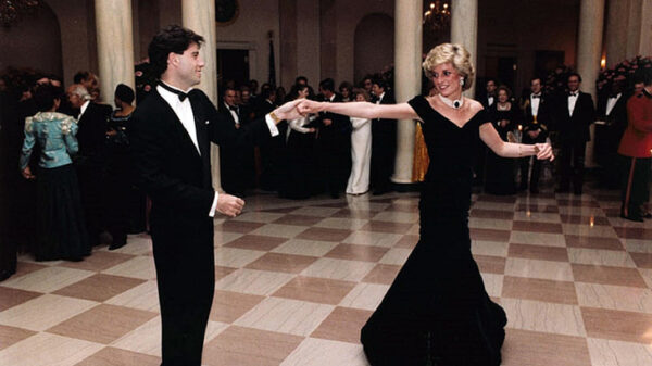 A man in a suit and a woman in dressing gown dancing