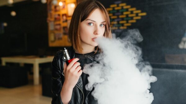 Girl Smoking Electronic Cigarette for Vaping Article