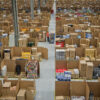 Rows upon rows of stacked boxes in an Amazon warehouse pictured from an arial viewpoint