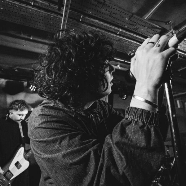 'Pastel' singer Jack Yates hangs off the microphone in black and white
