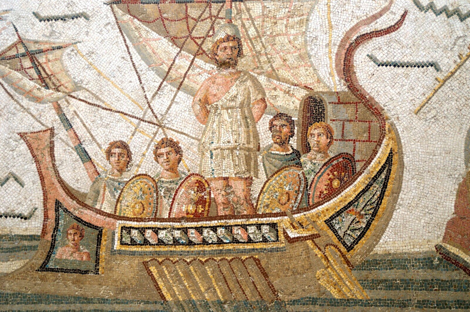 Ancient mosaic of men on a ship with sails