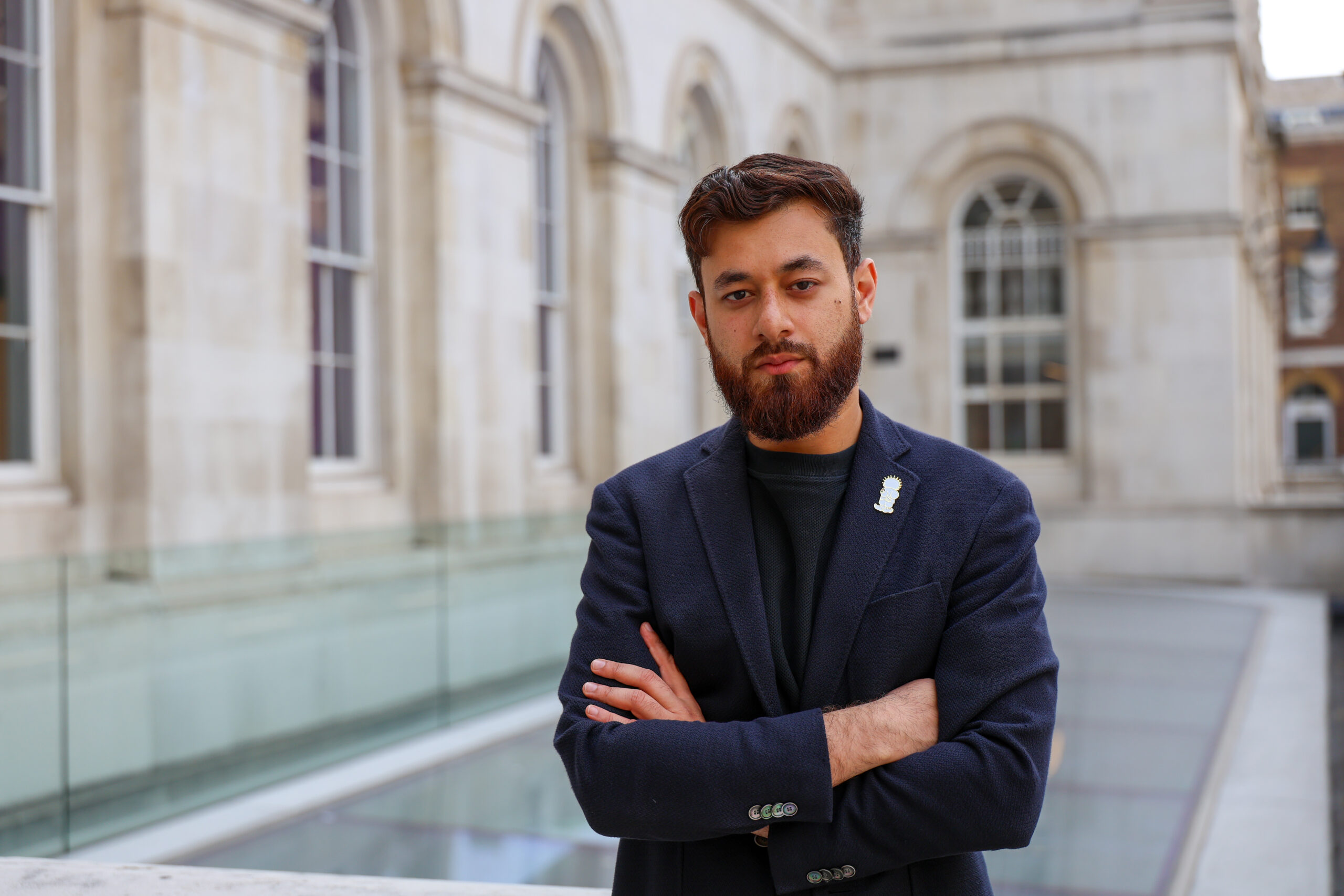 KCLSU president Luqmaan Waqar with folded arms