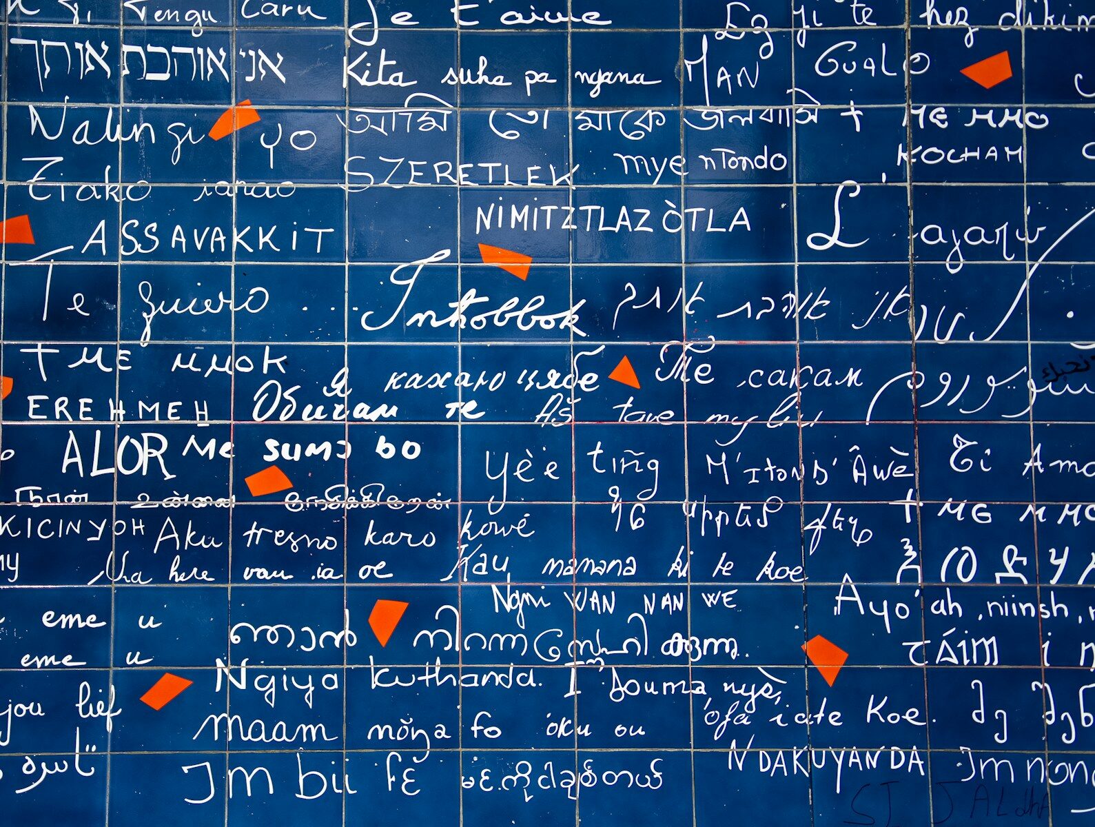 a bunch of writing on a blue wall